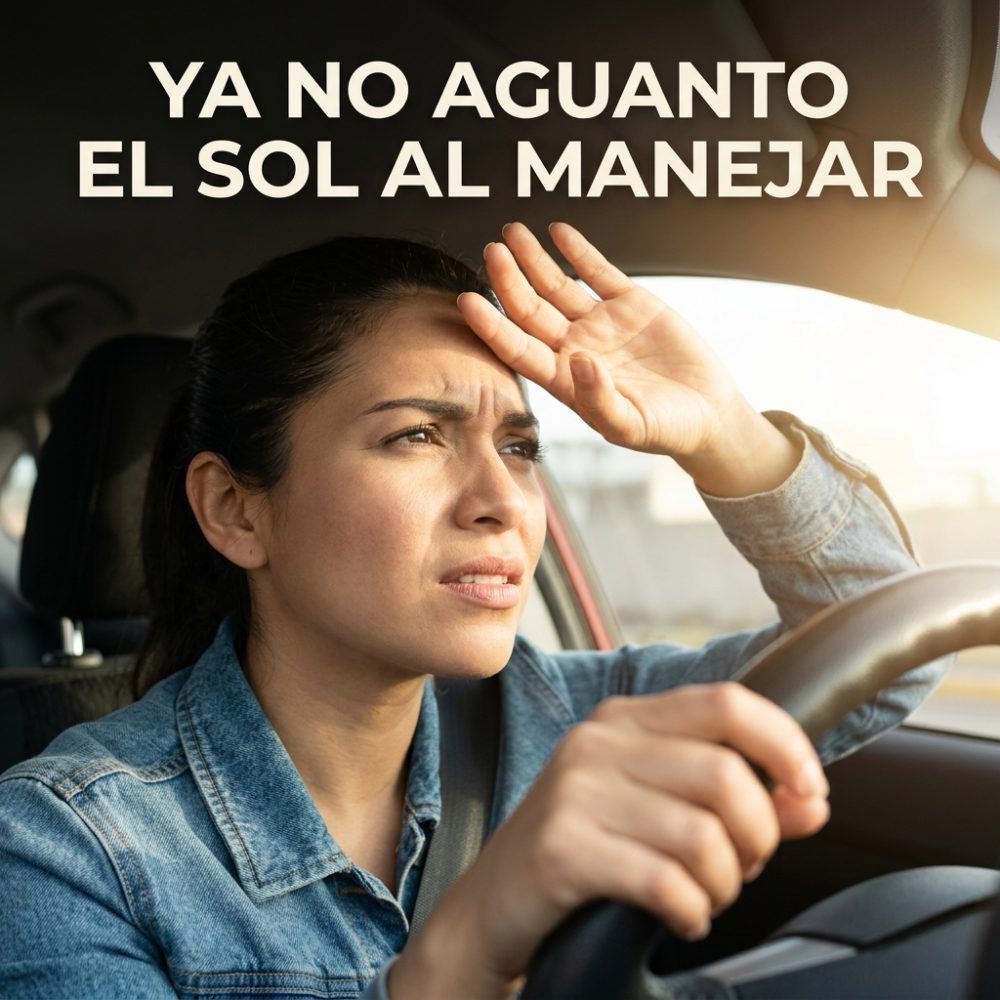Conductora tapándose el sol con la mano mientras maneja